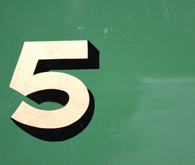 A number five on a gold background.