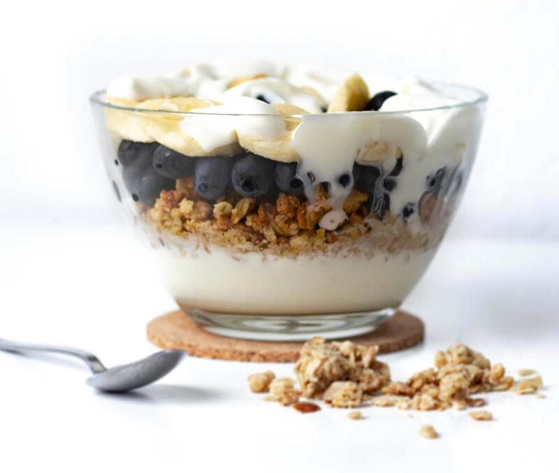 A yogurt and fruit filled parfait breakfast.