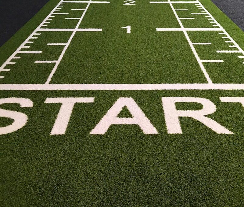 a lined green field with the word start writen in white