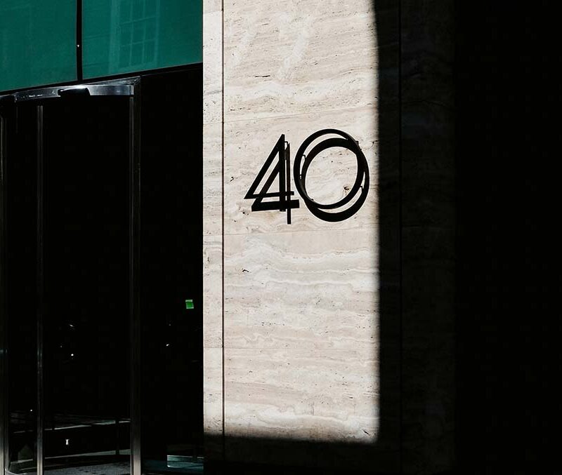 The number 40 on a wall framed by shadows.