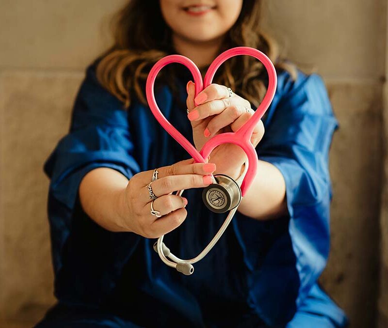 A photo of nurse holding a stethascope shaped like a heart